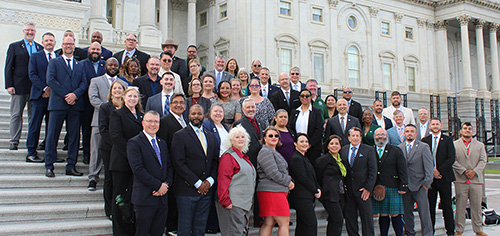 60 PASS members standing on the steps of the U.S. Capitol.